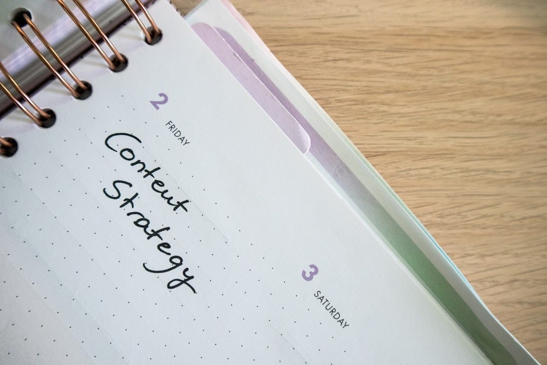 Content calendar and planning board on a desk with sticky notes and laptop