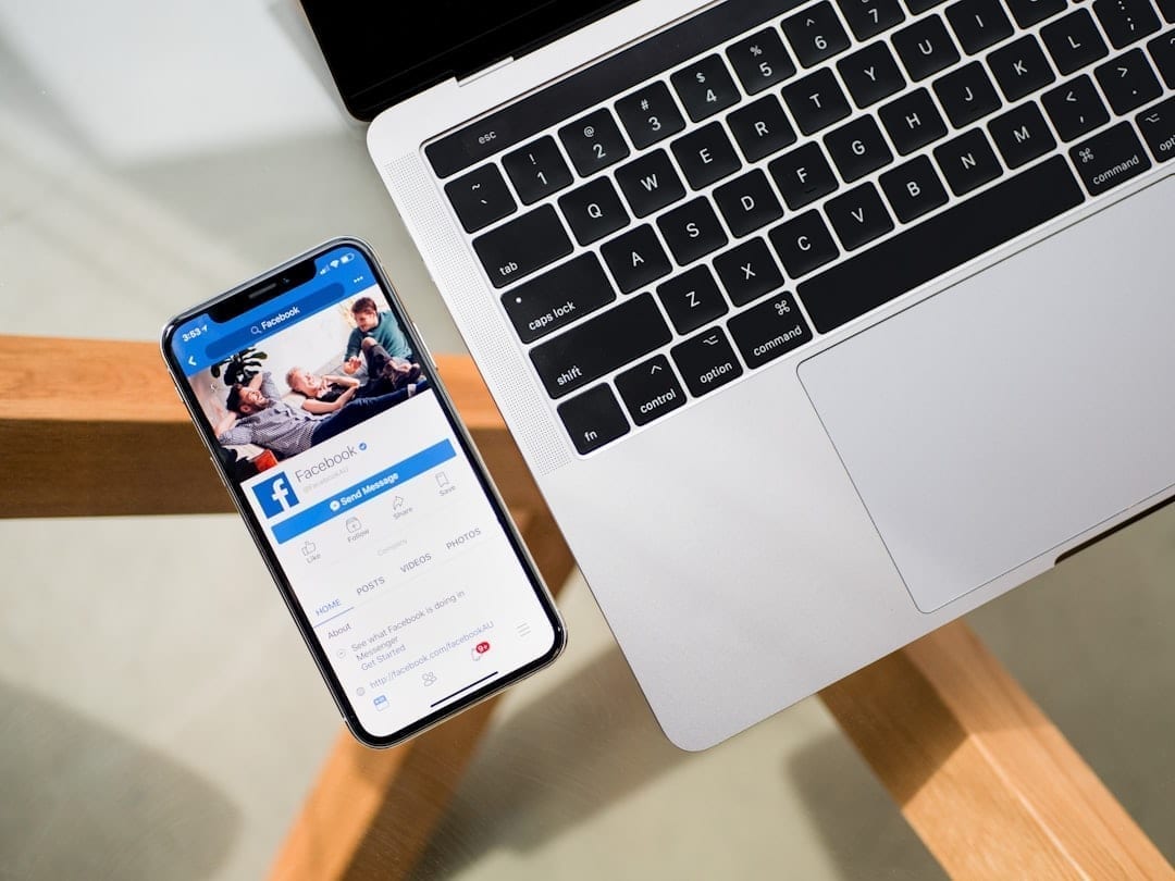 Social media manager moderating Facebook Page comments on a laptop