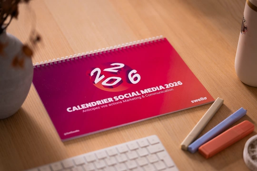 Social media strategist planning hashtag sets on a laptop and phone