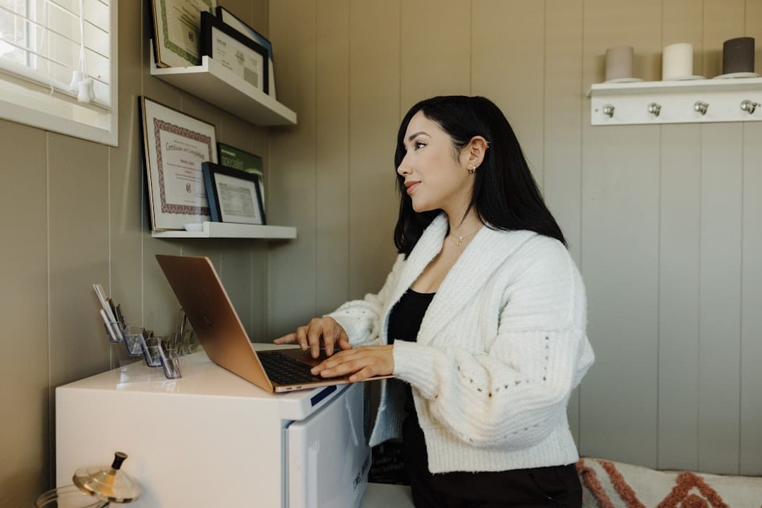 Small business owner planning social media posts on a laptop